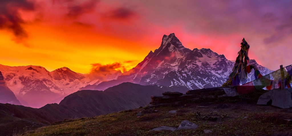 Uttarakhand Sacred Places surrounded by majestic Himalayan mountains during a colorful sunrise