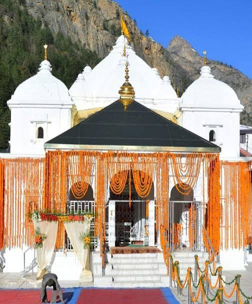 The History and Legends Behind Uttarakhand's Famous Temples Badrinath Temple decorated with marigold flowers in Uttarakhand.